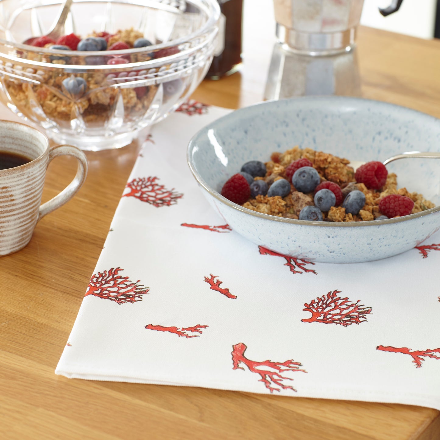 coral tea towel granola  breakfast setting on the kitchen salad.
